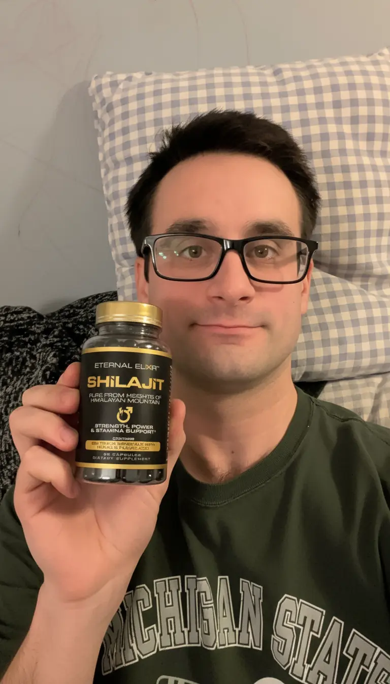 Man in glasses holding a bottle of Eternal Elixir Shilajit capsules
