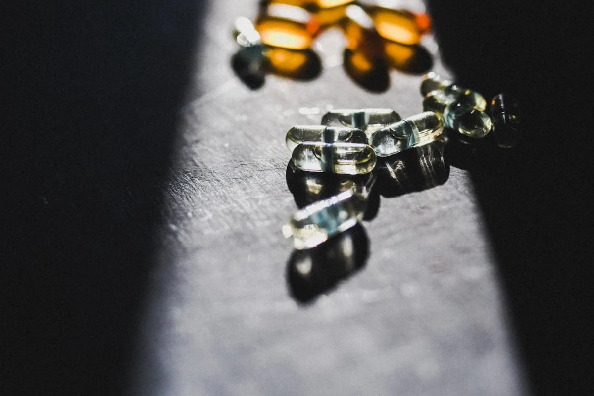 Translucent vitamin E oil capsules in directional light