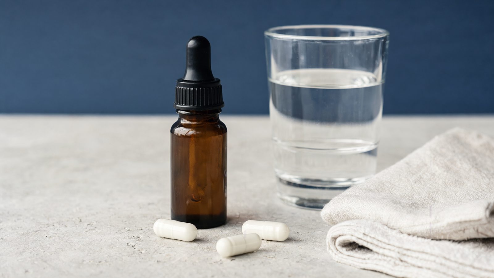 Methylene blue side effects guide: dropper bottle and capsules beside a glass of water