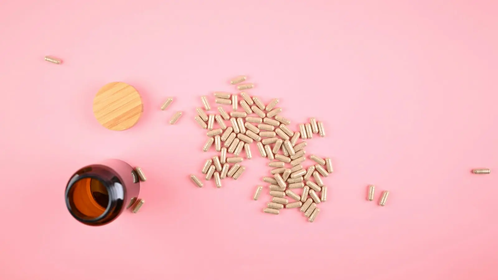 Nicotinamide riboside benefits: NR capsules spilled from an amber bottle